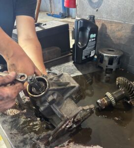 Mechanic hands disassembling automotive differential