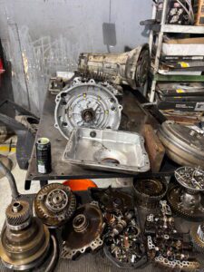 Disassembled automatic transmission parts on workbench
